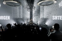 a group of people at a party with confetti in the air