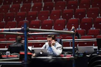 a man sitting at a desk with a laptop in front of him