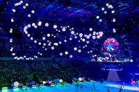 a group of people are skating on an ice rink